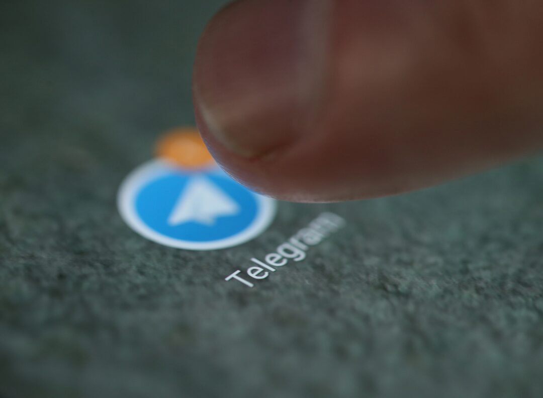Lagos market merchants using smartphones for USDt payments via Telegram on TON blockchain